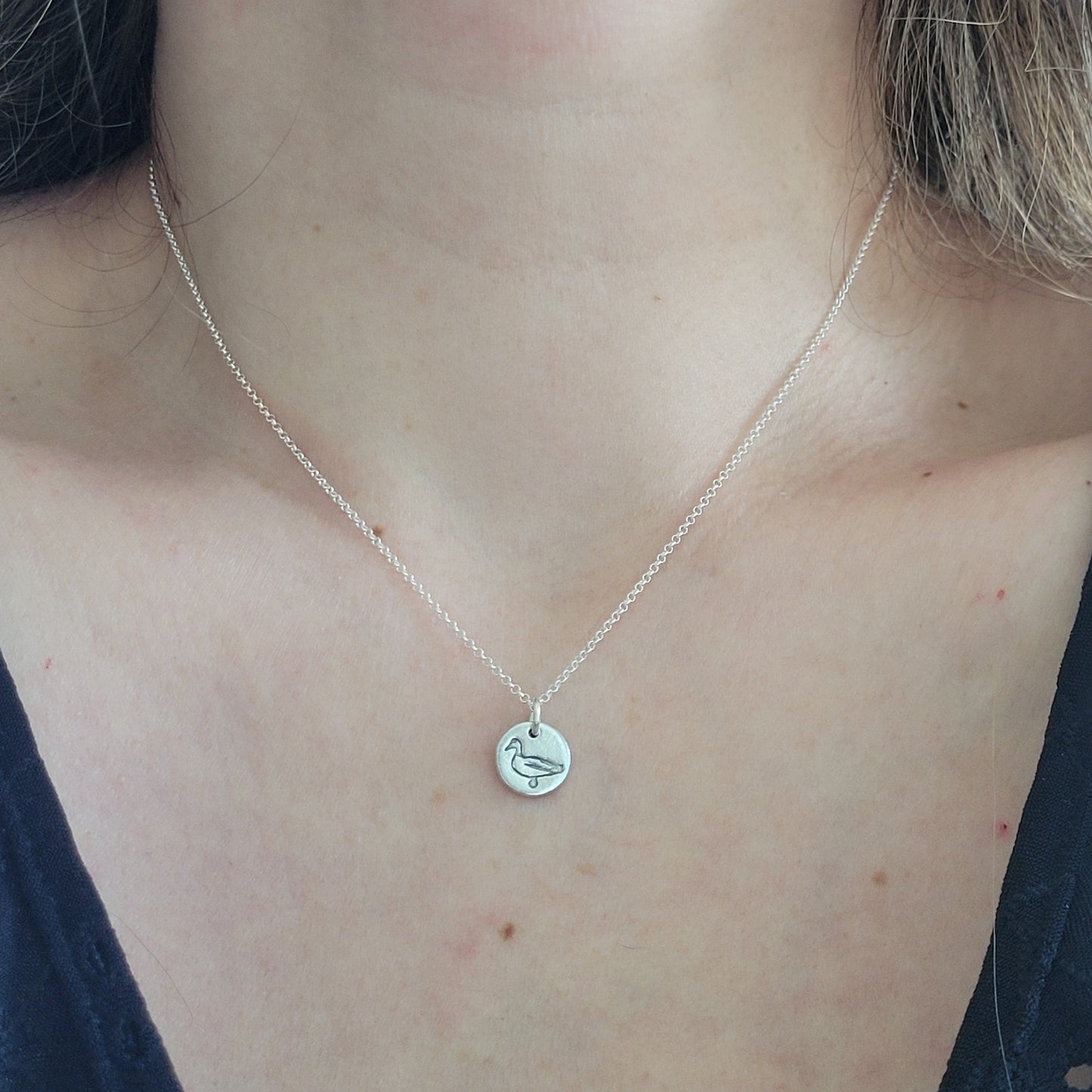 Sterling-silver-tiny-duck-bird-pendant-necklace-worn