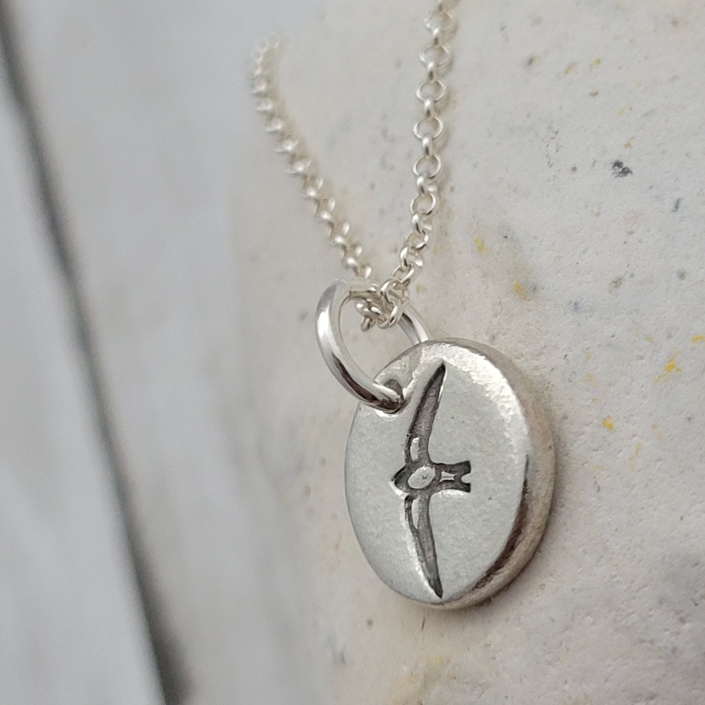Round sterling silver swallow bird pendant necklace side view