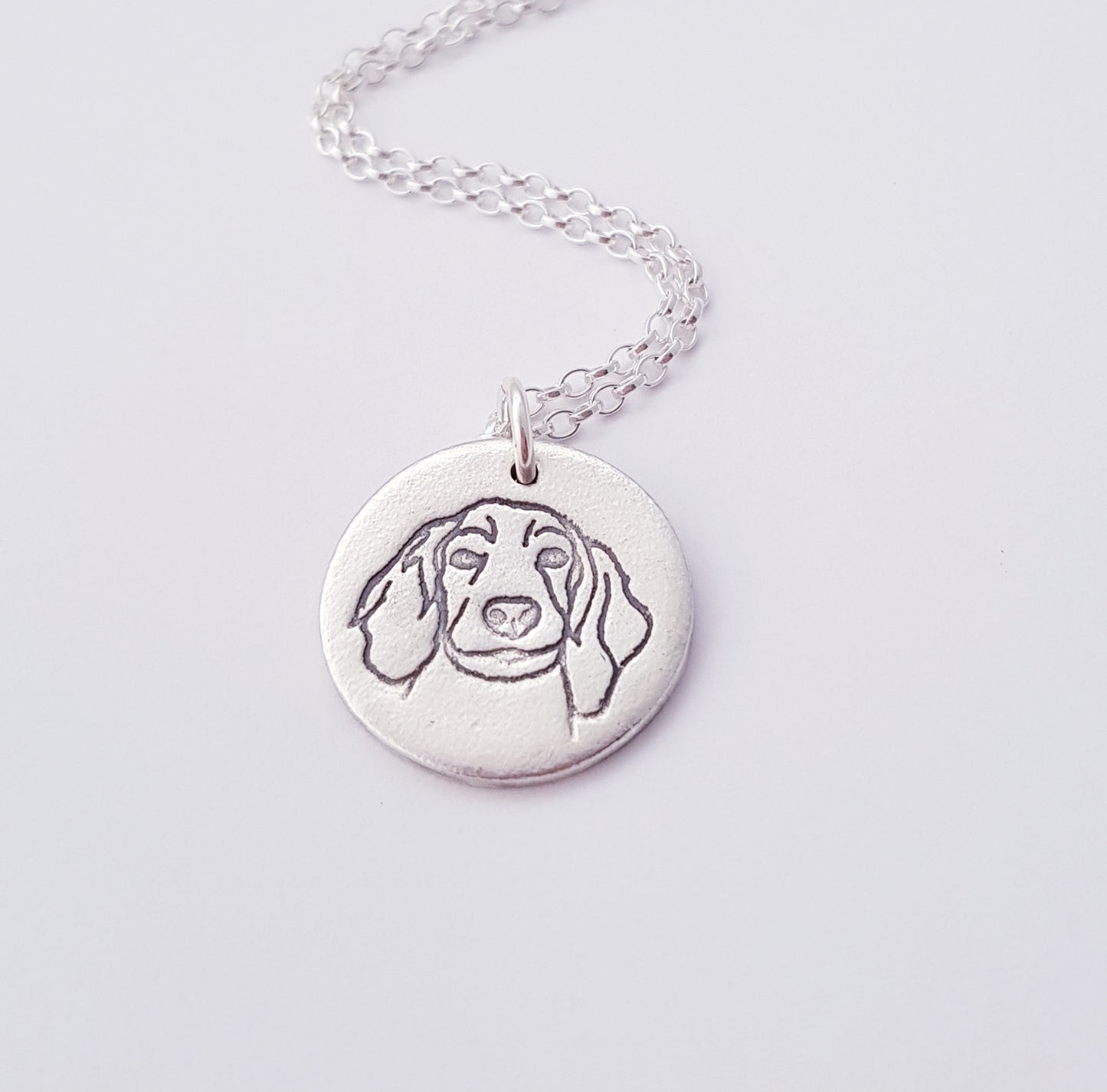 spaniel dog portrait silver pendant on white background