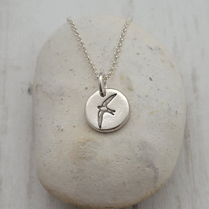 Sterling silver round swallow bird pendant on a stone