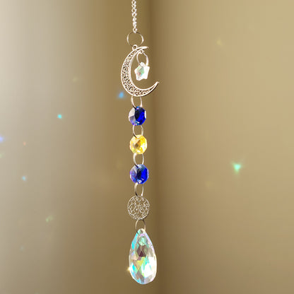 moon and star suncatcher with colourful blue and yellow crystals on a beige background