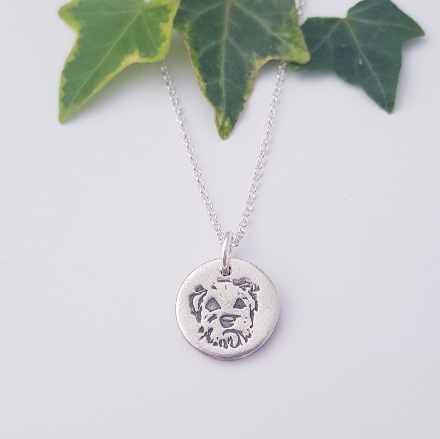 border terrier dog pendant on white background