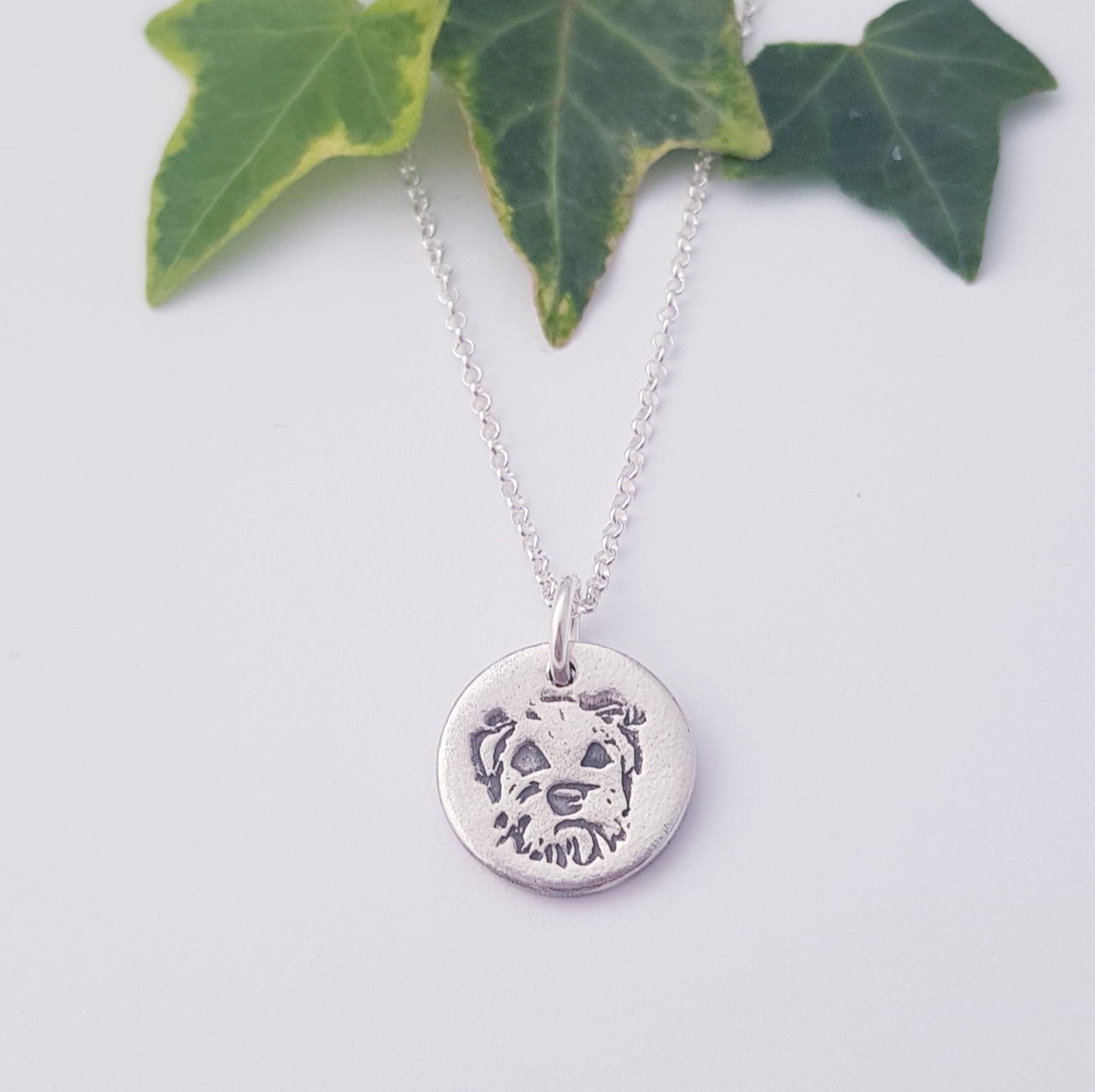 border terrier dog pendant on white background