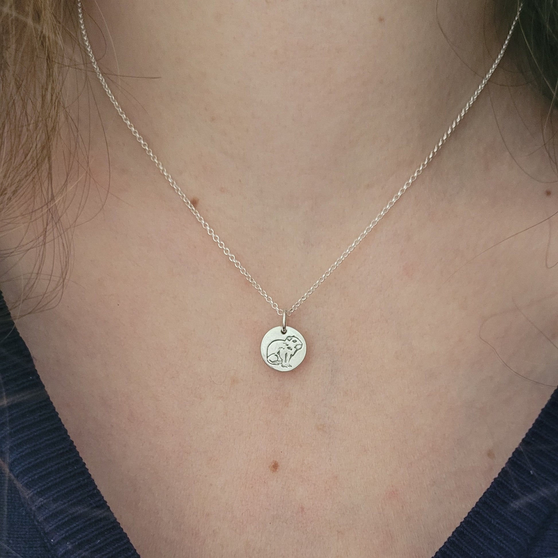 capybara necklace silver being worn