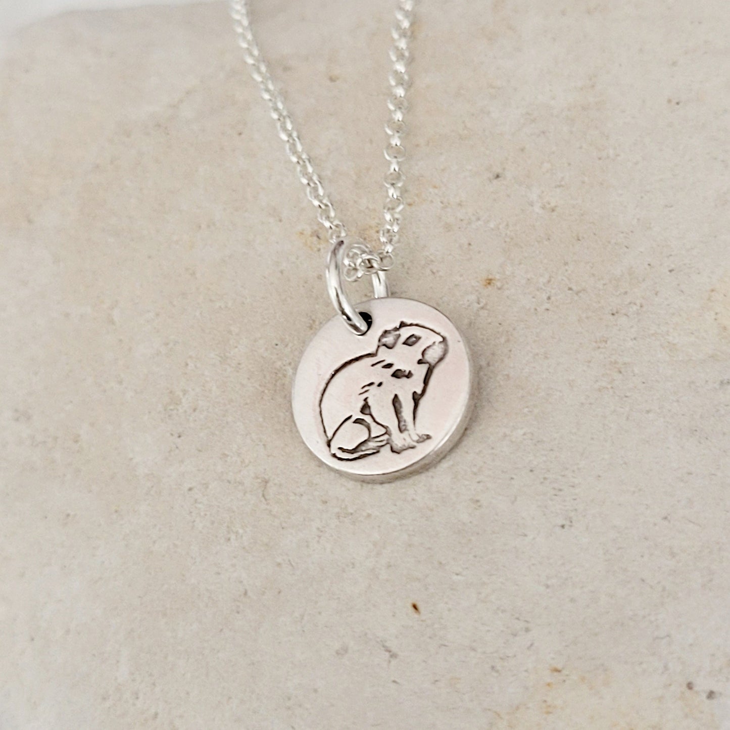 sterling silver round capybara pendant on white stone