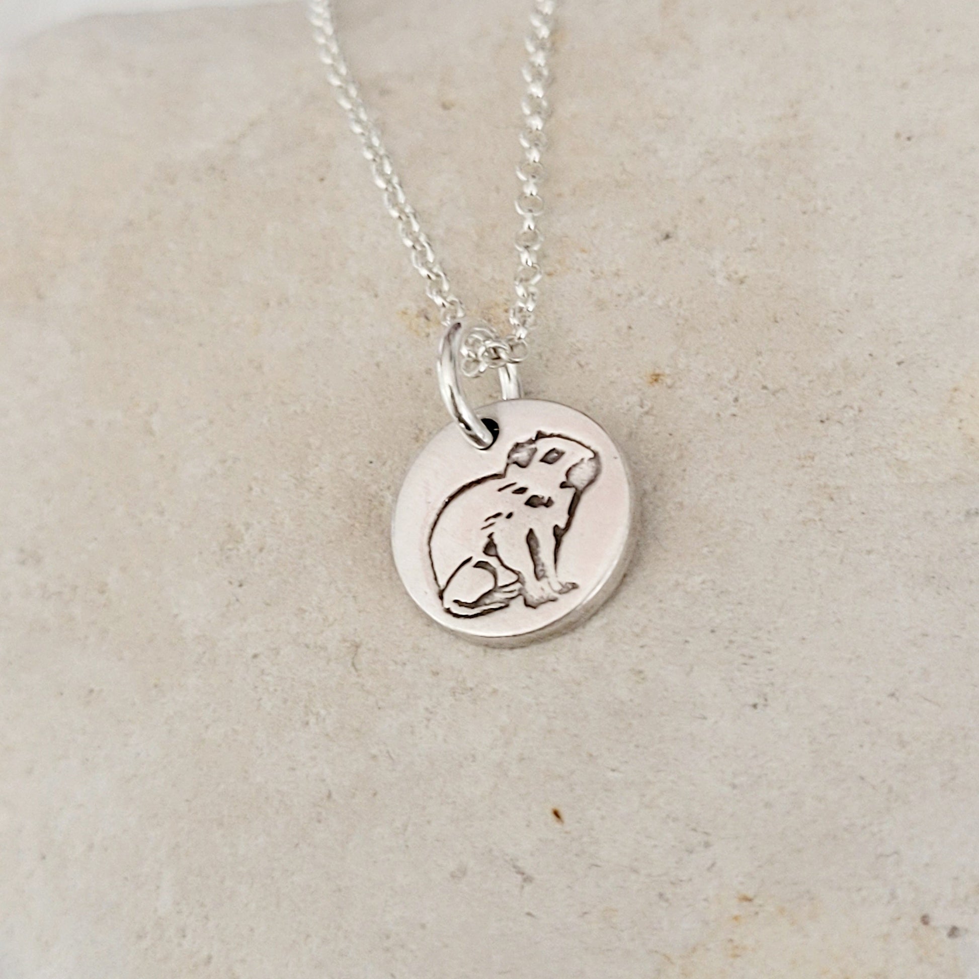 sterling silver round capybara pendant on white stone