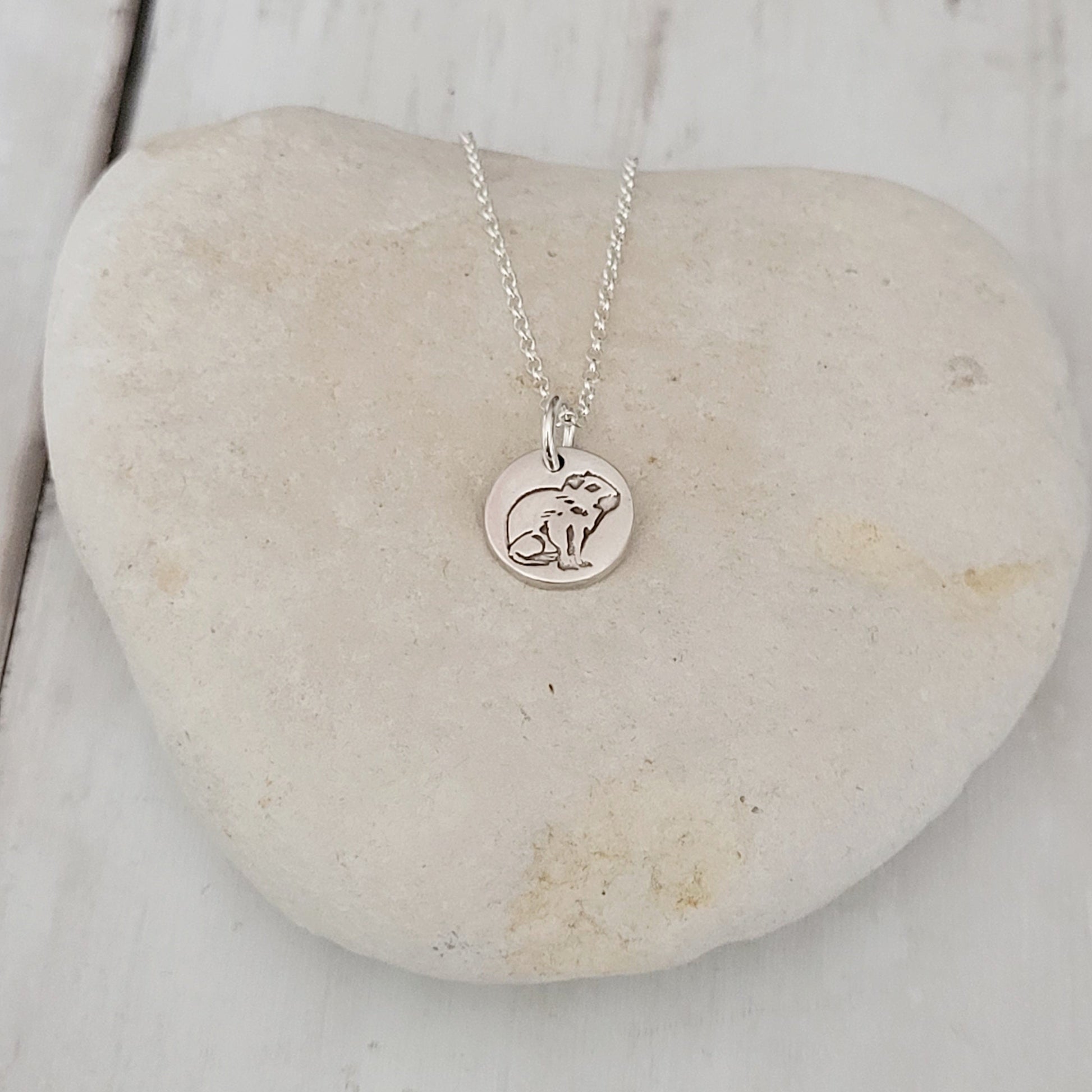 sterling silver capybara round pendant on stone