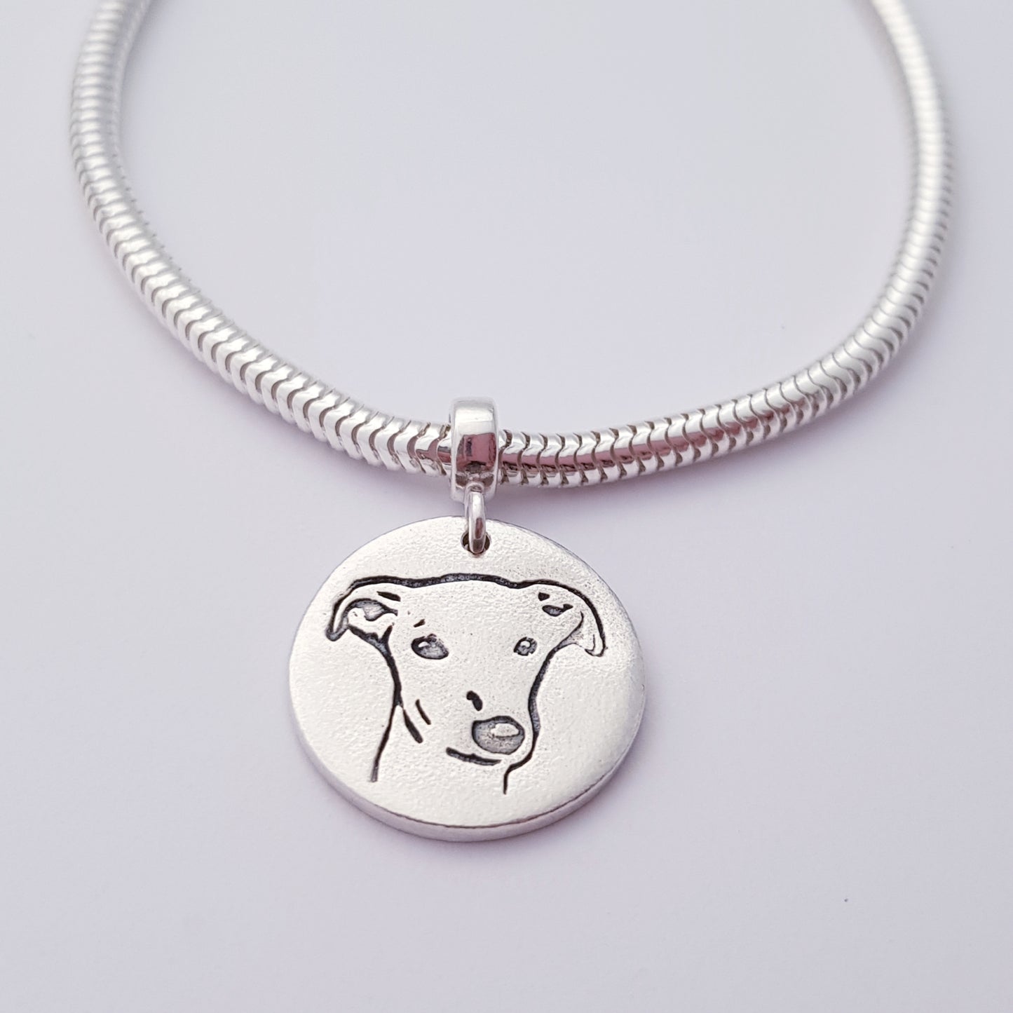greyhound dog pendant hanging on snake chain
