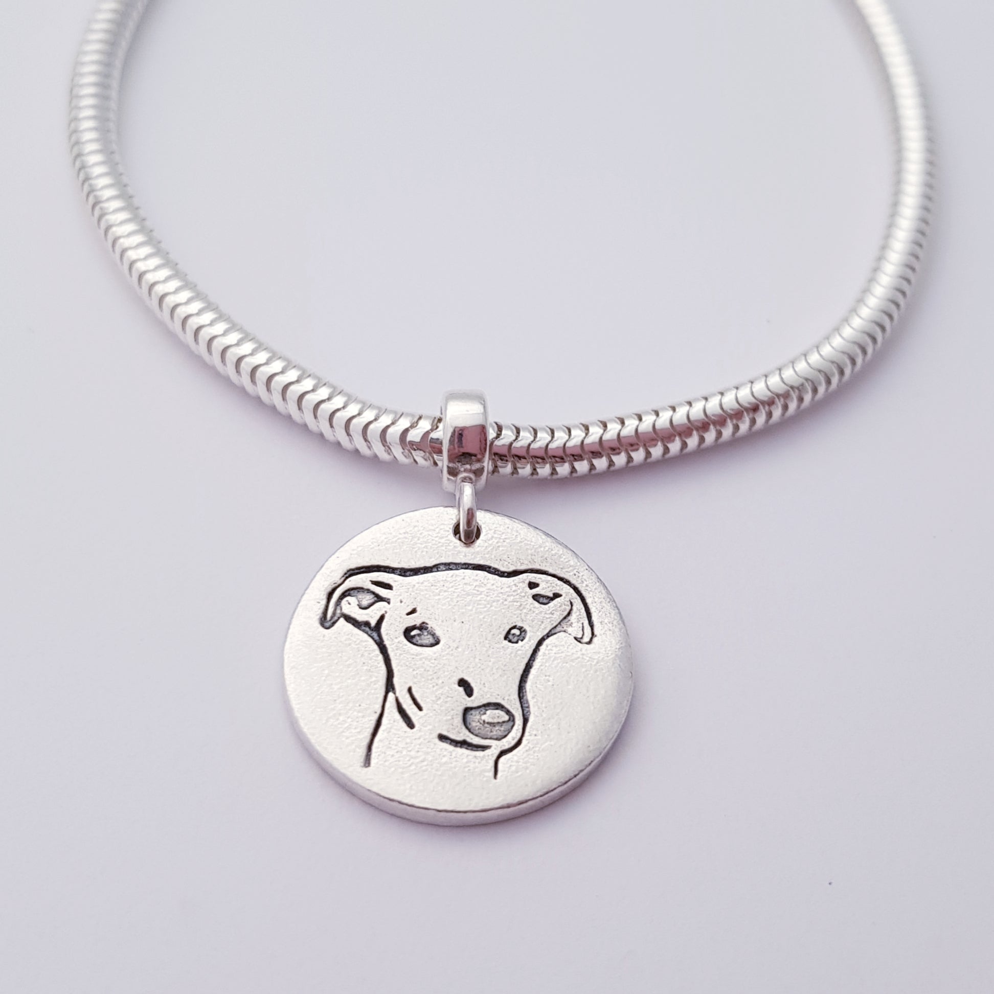 greyhound dog pendant hanging on snake chain