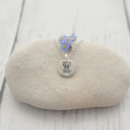 animal necklace on white stone