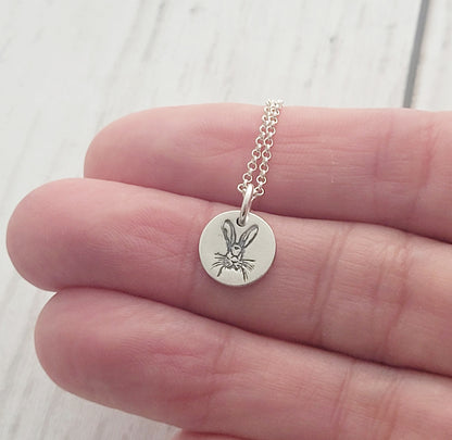 round hare necklace held in hand