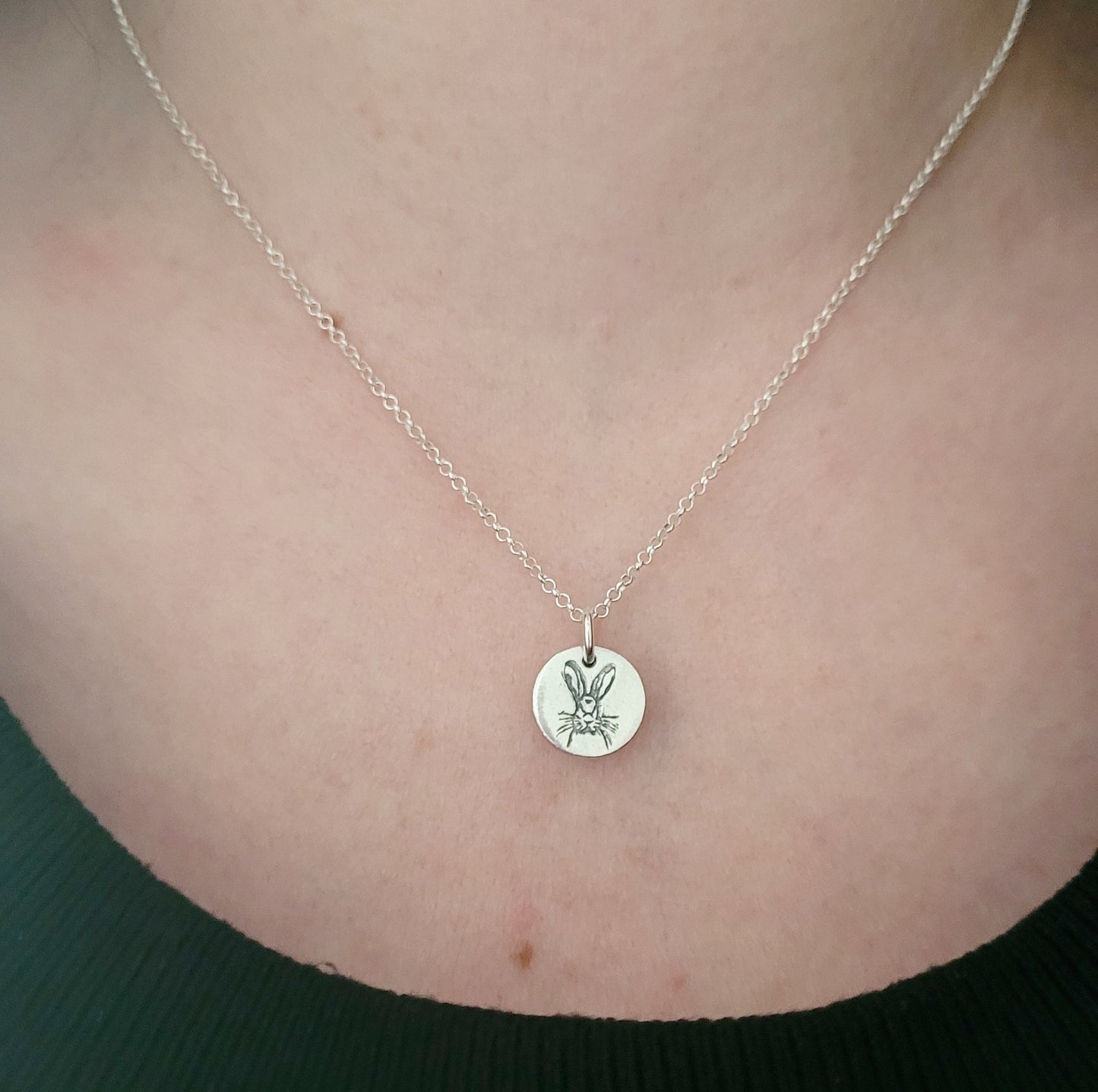 sterling silver hare pendant being worn