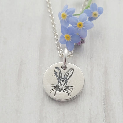 round silver hare necklace with forget me not flowers