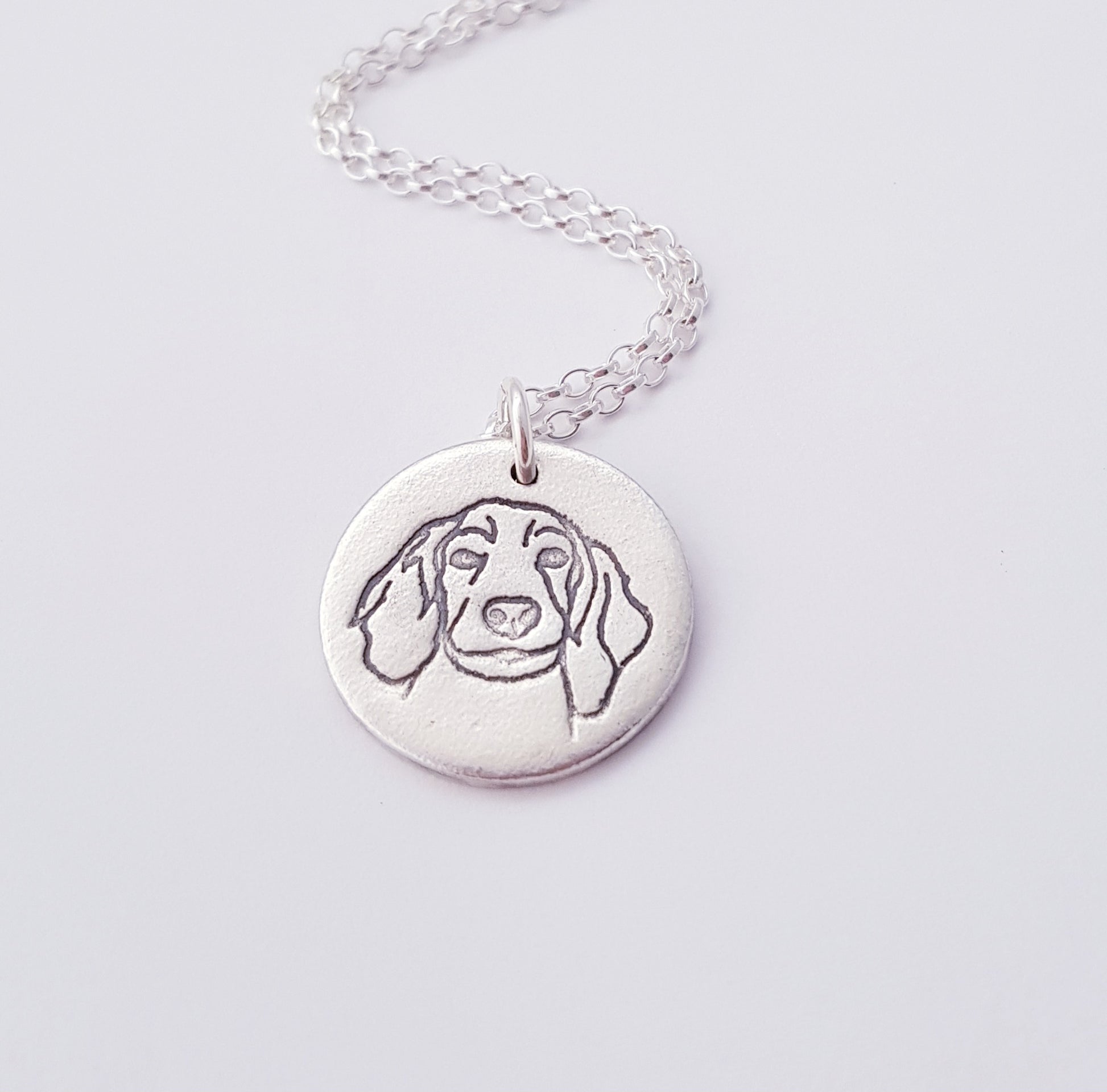 spaniel dog portrait silver pendant on white background