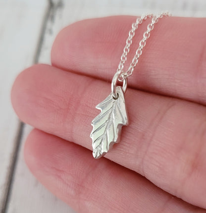 silver leaf necklace held side on
