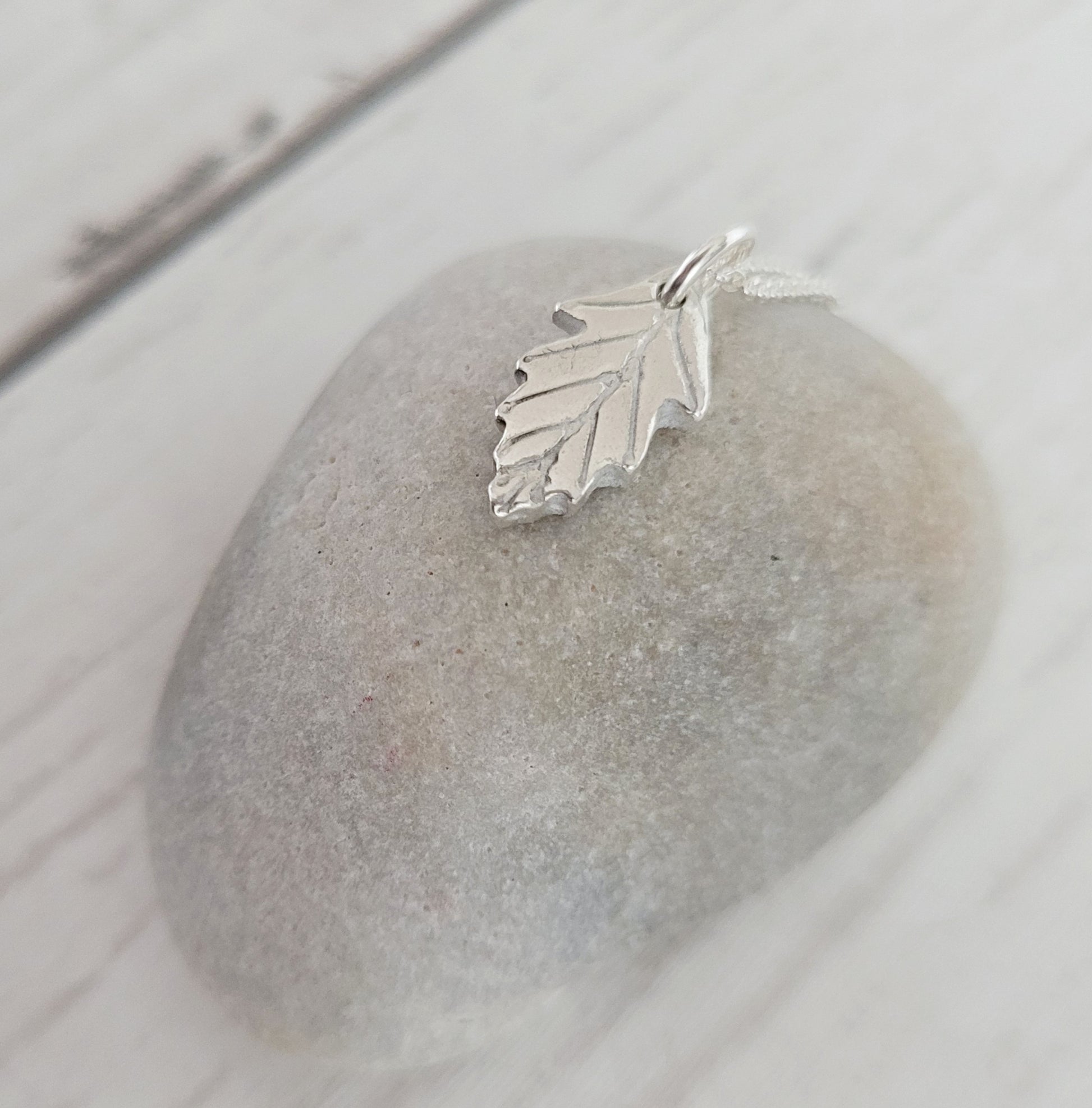 sterling silver oak leaf pendant shown side on stone