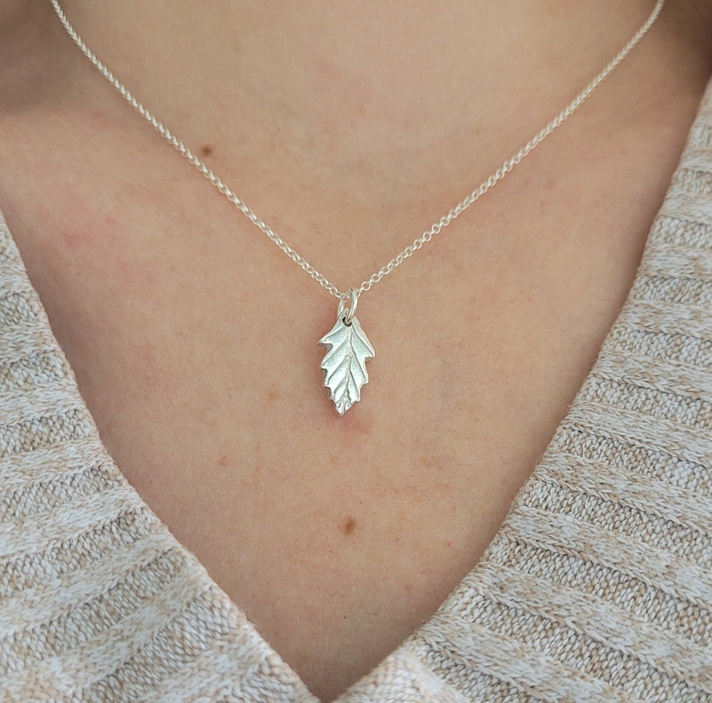 silver oak leaf pendant being worn