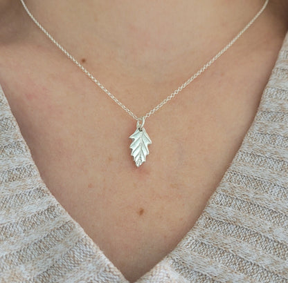 silver oak leaf pendant being worn