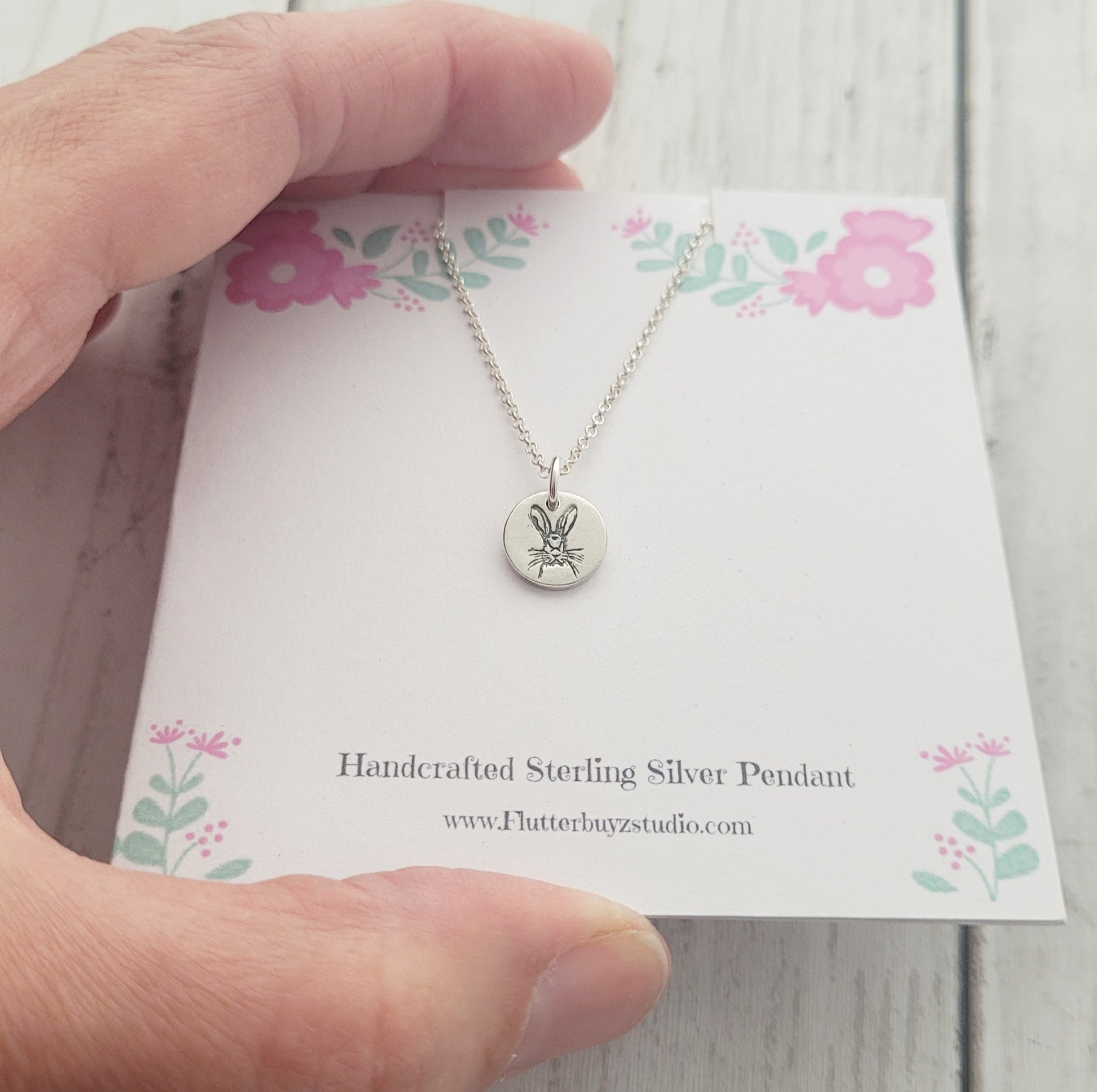 hare animal pendant on pink flower card